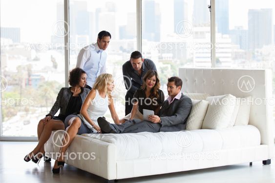 Attractive group of young people getting together after work before a party
