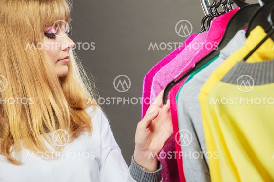 Pretty girl watching new clothes.