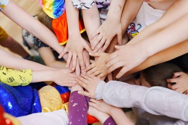 Lots of children's hands put together. Happy childhood...