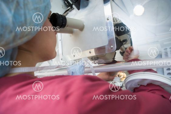 Embryologist adding sperm to egg