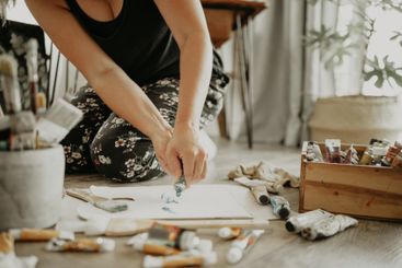 Painter, paper and creative woman with tube of paint,...