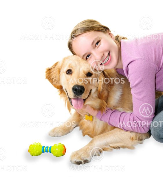 Girl hugging golden retriever dog