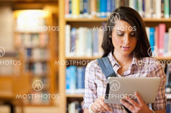 Young focused student using a tablet computer