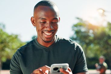 Outdoor, black man and fitness with mobile for chat,...