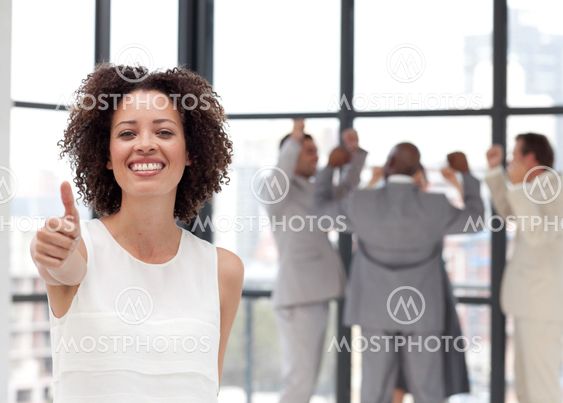 Joyful Businesswoman doing a thum-up with his colleagues