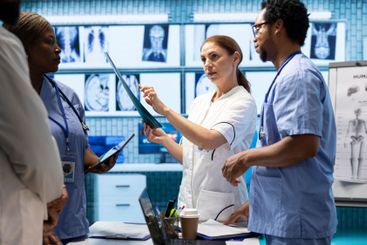 Doctors and nurses analyze human anatomy scans results...