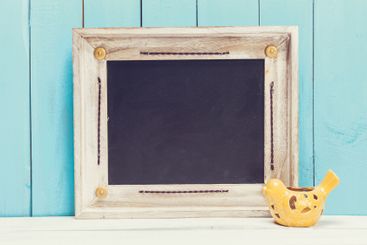 Cozy pastel wooden home decor objects on blue background