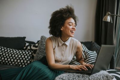 Attractive young woman working on laptop at home
