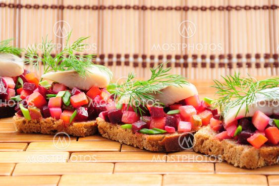 Sandwiches with rye bread, herring and vegetables