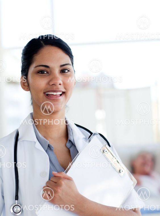 Smiling female doctor holding a medical clipboard