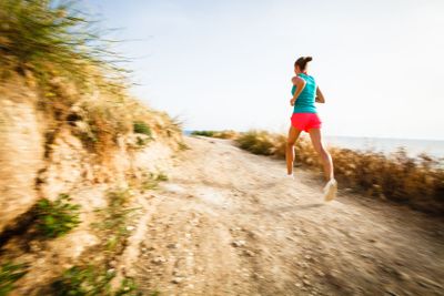 Young woman on her evening jog along the seacoast 