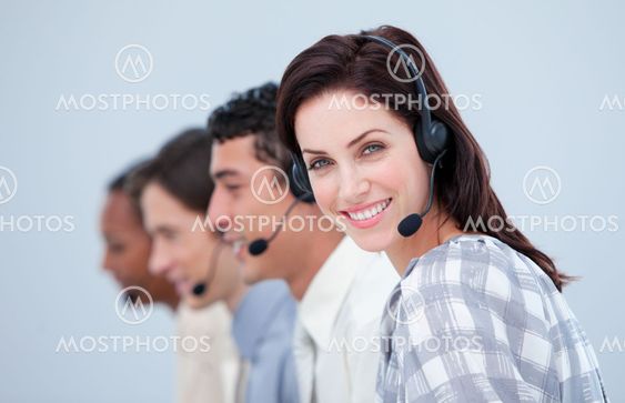 Attractive business woman and her team working in a call center