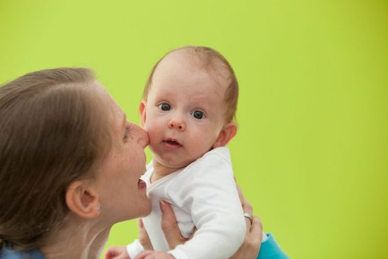 Mother playing with her beautiful little baby