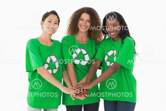 Team of environmental activists smiling at camera with hands together