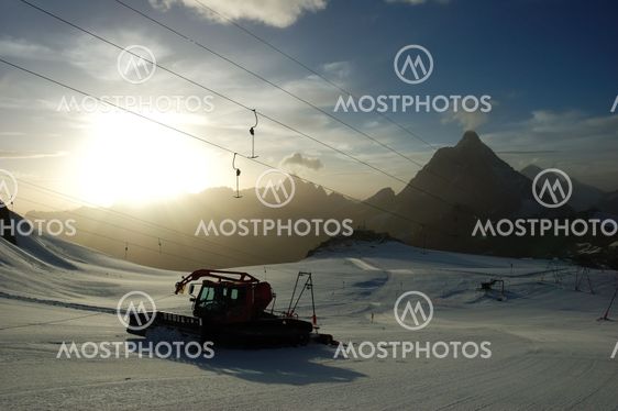 Sunset ski slope snowplow