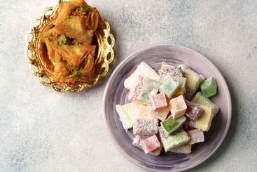 Sweets served on elegant plates display traditional...