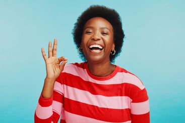 Portrait, perfect and black woman in studio, smile or...