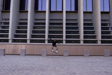 Skateboard, stunt and man in city for outdoor activity,...