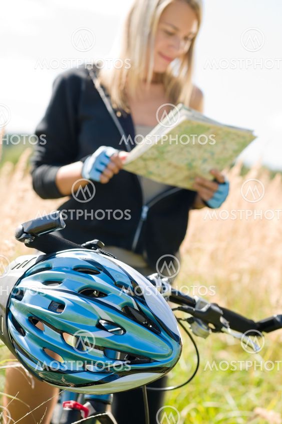 Mountain biking young woman search in map