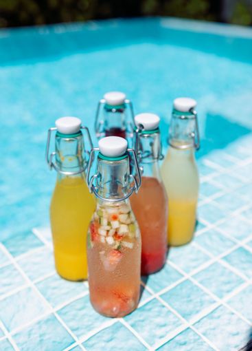 Close-up of fragrant cocktails in glass bottles on the...