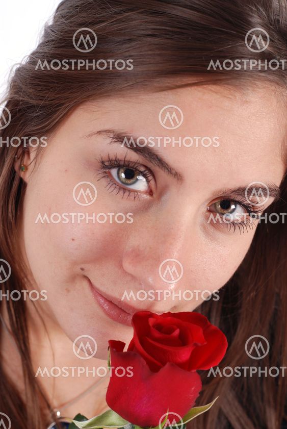 Young girl smelling a rose