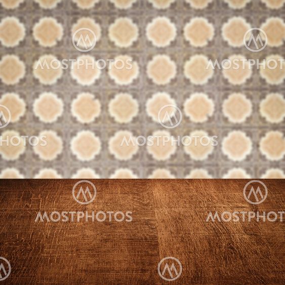 Wood table top and blur vintage ceramic tile pattern wall