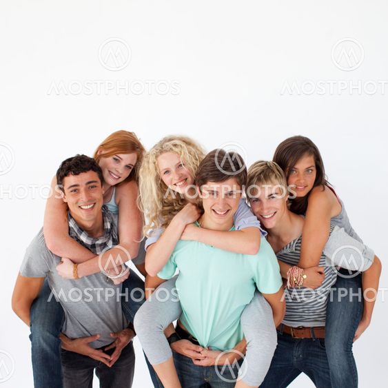 Teenagers giving their friends piggyback rides