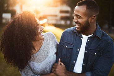 Love, couple and laughing at park together for sunset...