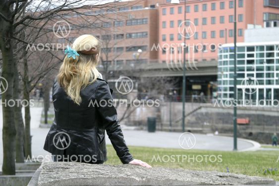 Woman Sitting in City