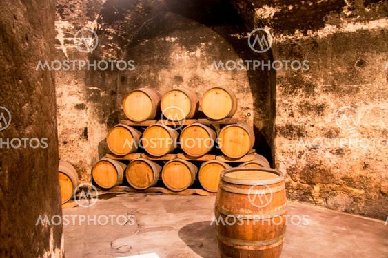 Old wooden barrels in the wine cellar of monastery
