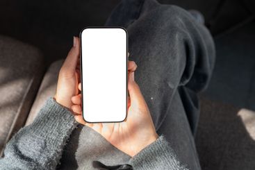 A close-up of a woman sitting indoors, sunlight...