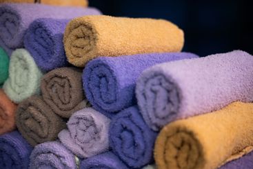 Neatly folded colorful towels arranged in a hospital...