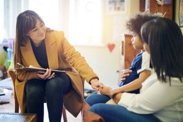 Mother, child and psychologist consultation in office...