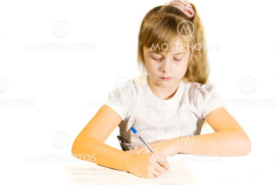 Beautiful little girl wrote in a notebook.