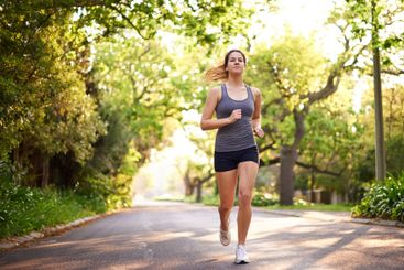 Running, fitness and woman with training, wellness and...