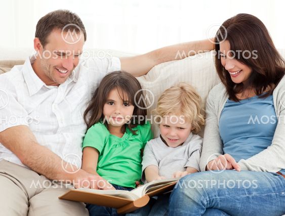 Cute girl and her family looking at a photo album