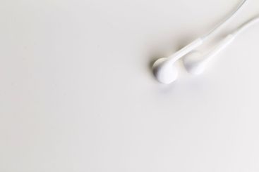 Pair of earphones close up on grey background