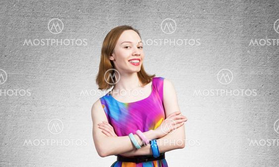 Smiling woman standing with folded arms