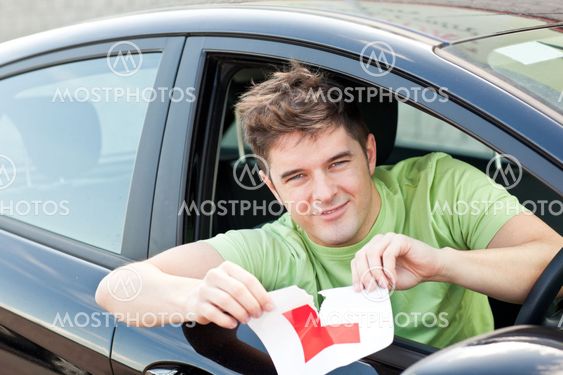 Happy young man cutting a "L" sign sitting