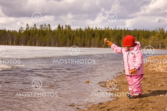 Girl throwing stones in the water