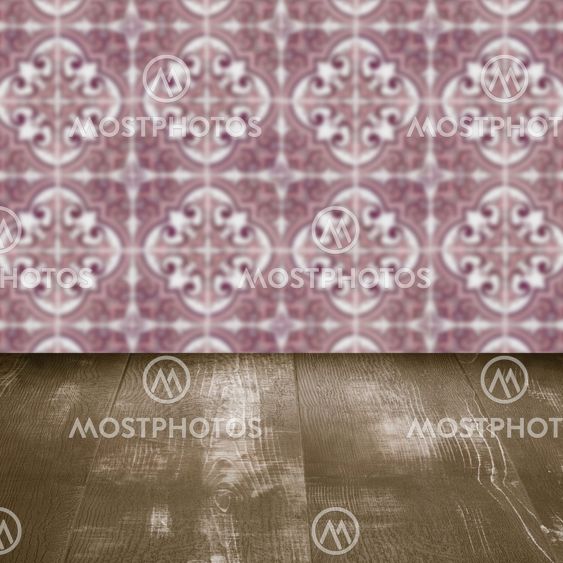Wood table top and blur vintage ceramic tile pattern wall