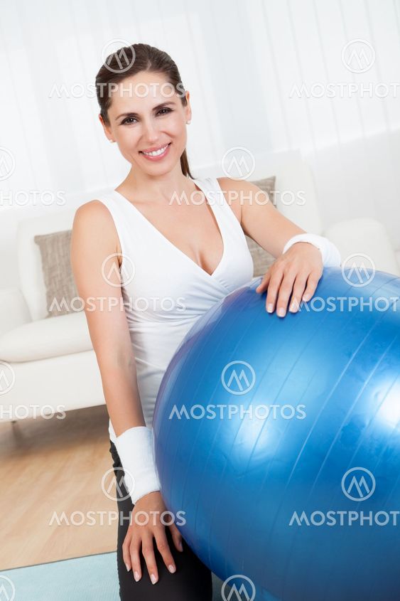 Happy woman with a pilates ball
