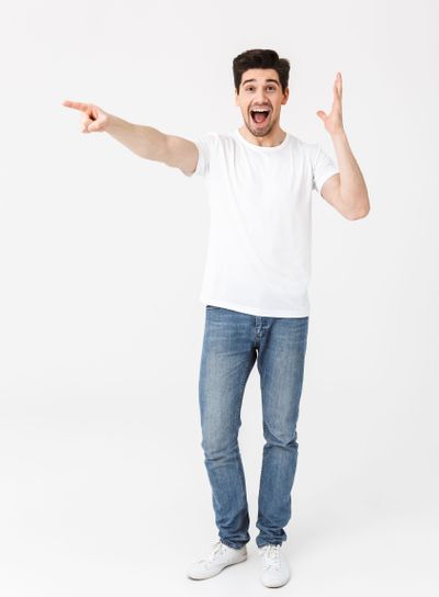 Full length portrait of a cheerful young man