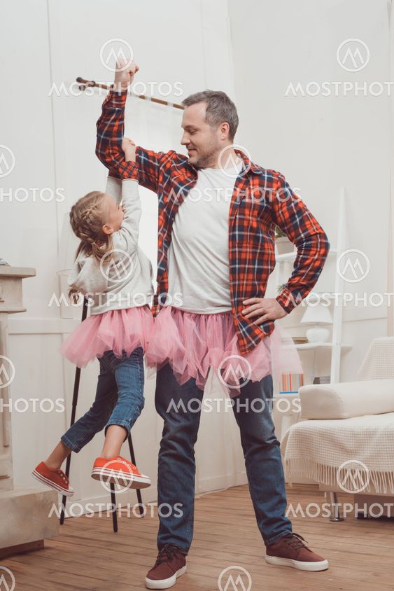 father and daughter in pink skirts