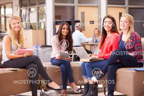 Female College Students Sitting And Talking Together
