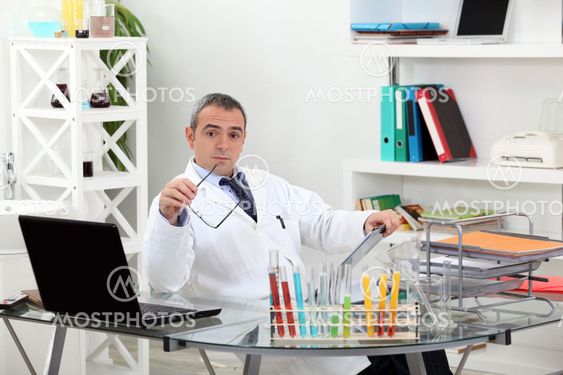 important scientist in his office raising eyebrows