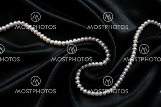 White pearls on the black velvet background