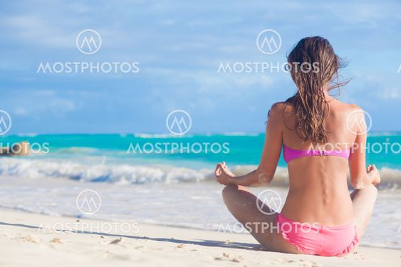 back view of long haired woman in bikini on tropical beach