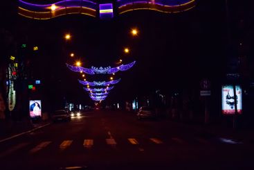 Night city road decorated by illumination for Christmas...