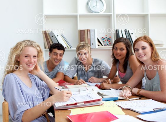 Teenagers doing homework in the library